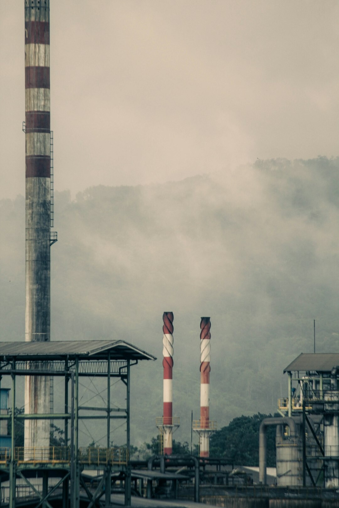 Industrial factory complex with chimneys and pipelines